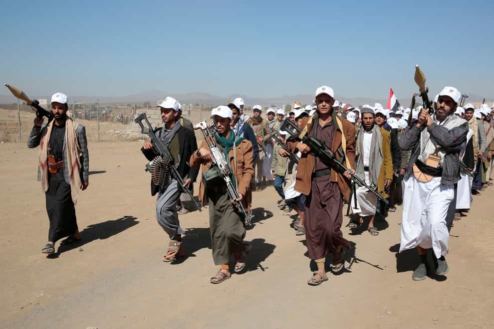 Houthi fighters stage a rally against the US government (Osamah Abdulrahman/AP)