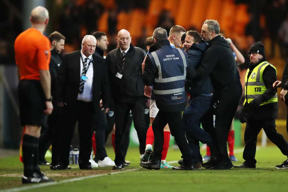 A Port Vale fan is restrained after running onto the pitch (Jess Hornby/PA)