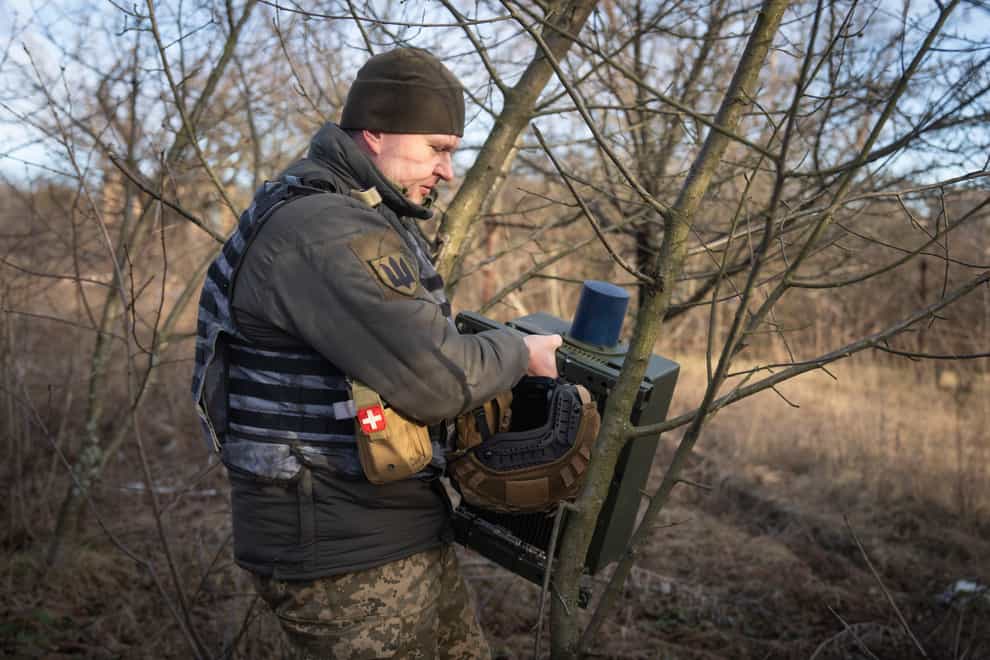 A Ukrainian serviceman installs an electronic warfare system to quell Russian drones at the front line, near Bakhmut, Donetsk region, Ukraine, on Monday (Efrem Lukatsky/AP)