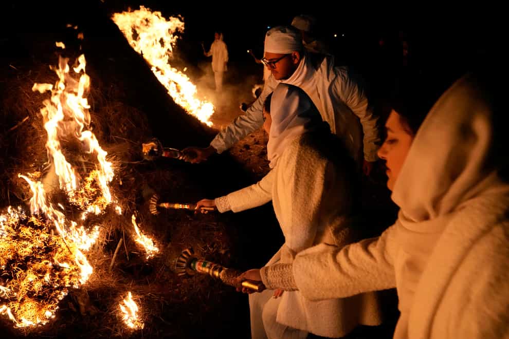 Iranian Zoroastrian youths set fire to a prepared pile of wood in a ceremony celebrating their ancient mid-winter Sadeh festival in the outskirts of Tehran (Vahid Salemi/AP)