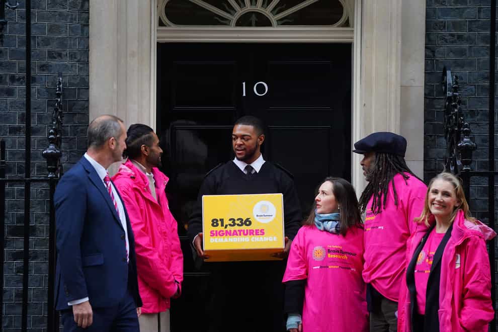 Brain tumour campaigners hand in a petition to Downing Street calling for more investment in research (Victoria Jones/PA)