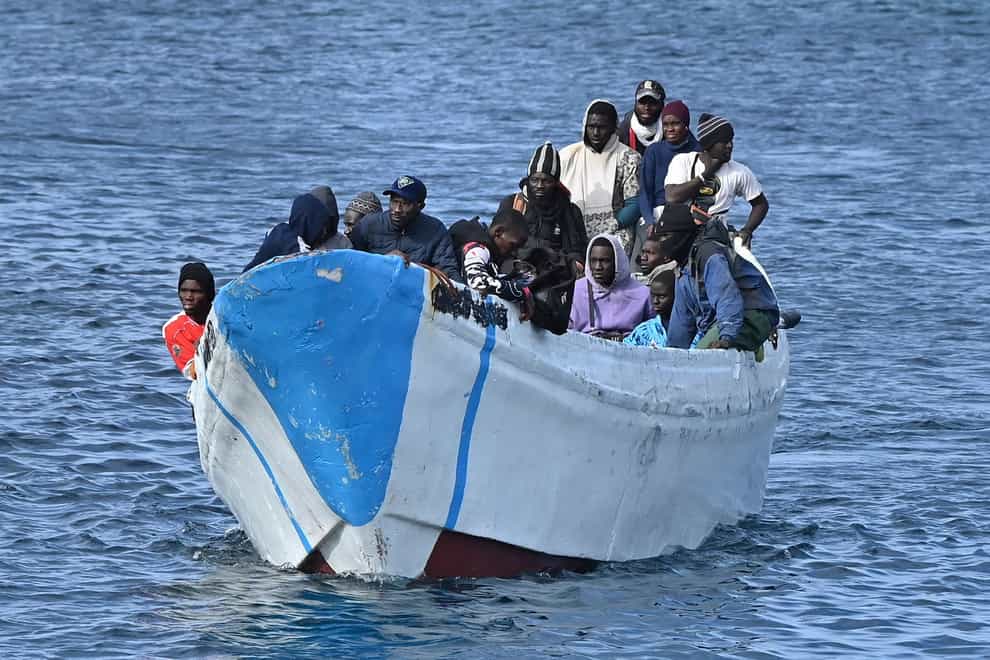 People thought to be migrants arrive on a small boat at La Restinga port on the canary island of El Hierro on Sunday (Europa Press via AP)