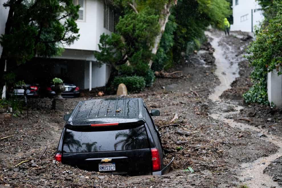 A vehicle buried by a mudslide in the Beverly Crest area of Los Angeles (Marcio Jose Sanchez/AP)