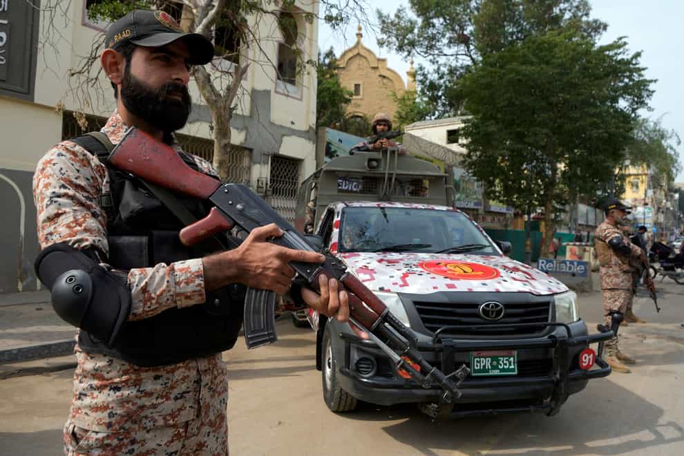 Paramilitary soldiers stand guard on the side of a road for security ahead of the February 8 general elections in Karachi, Pakistan (Fareed Khan/AP)