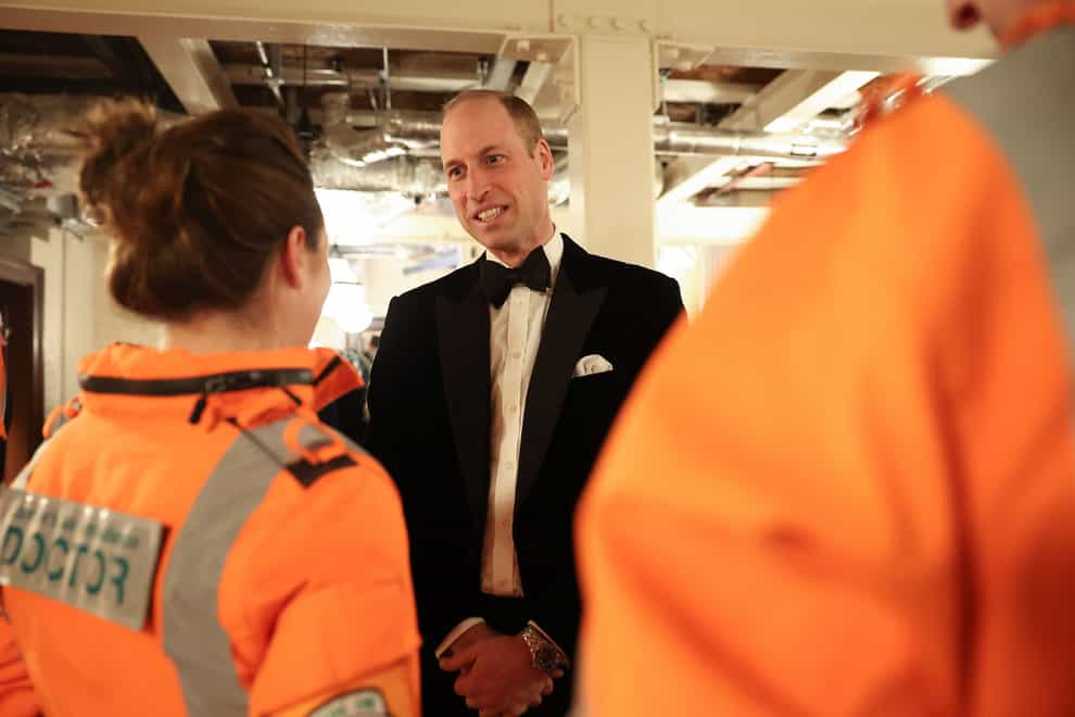 The Prince of Wales talks with air ambulance pilots, doctors and paramedics, at the London’s Air Ambulance charity gala dinner (Daniel Leal/PA)