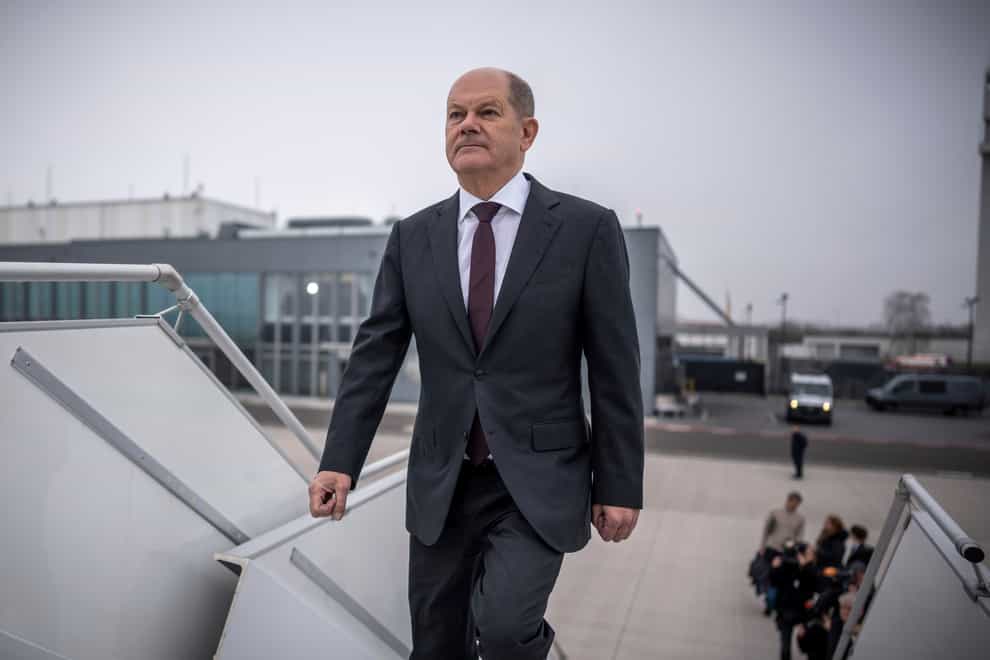 German Chancellor Olaf Scholz boards a plane at the military section of Berlin Brandenburg Airport to fly to the US (Michael Kappeler/AP)