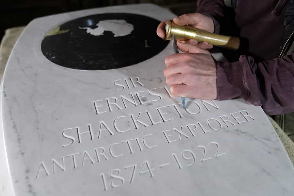 Stonemason Will Davies adds the finishing touches to a memorial stone for Sir Ernest Shackleton, ahead of a dedication in Westminster Abbey on February 15 (Andrew Matthews/PA)