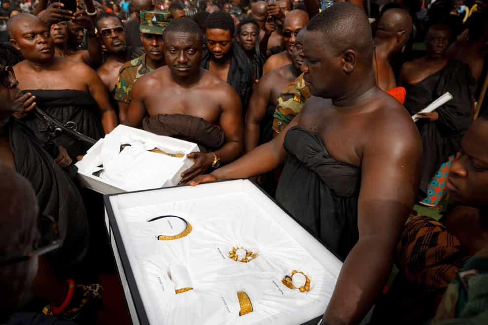 Artefacts returned from UCLA’s Fowler Museum are carried to the Manhyia Palace in Kumasi, Ghana (Misper Apawu/AP)