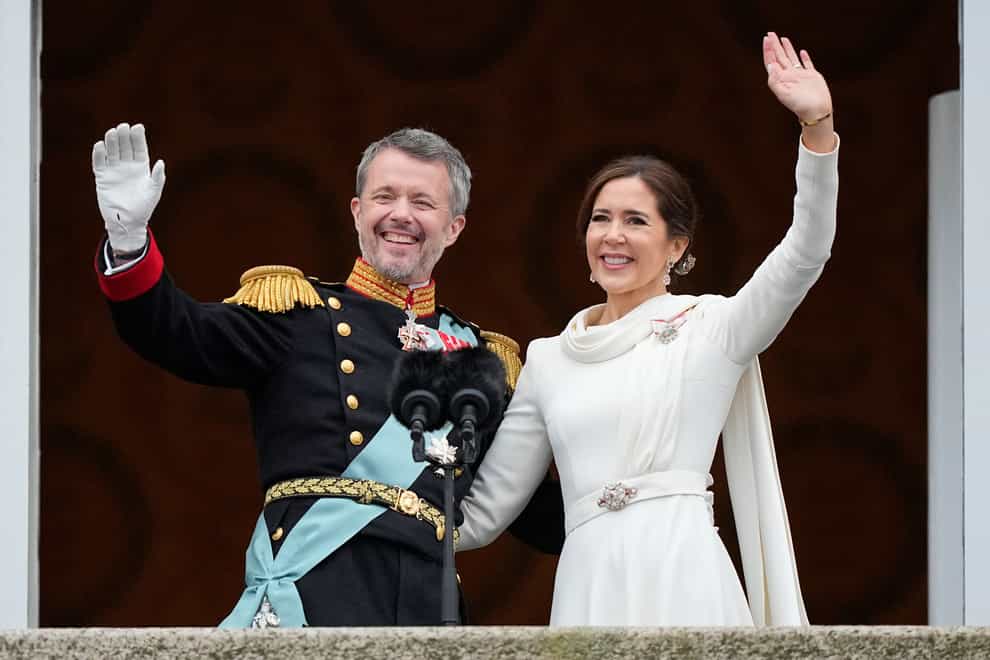 Denmark’s King Frederik X and Queen Mary wave from the balcony of Christiansborg Palace (Martin Meissner/AP)