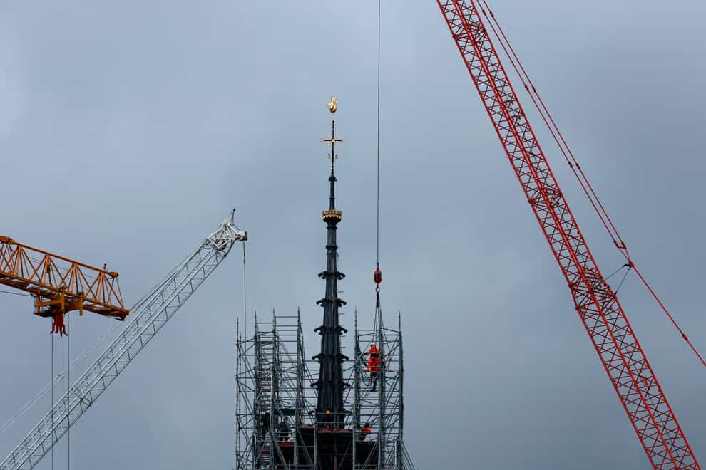 Scaffolding being removed around the spire of Notre Dame de Paris cathedral, showing the rooster and cross (Aurelien Morissard/AP)