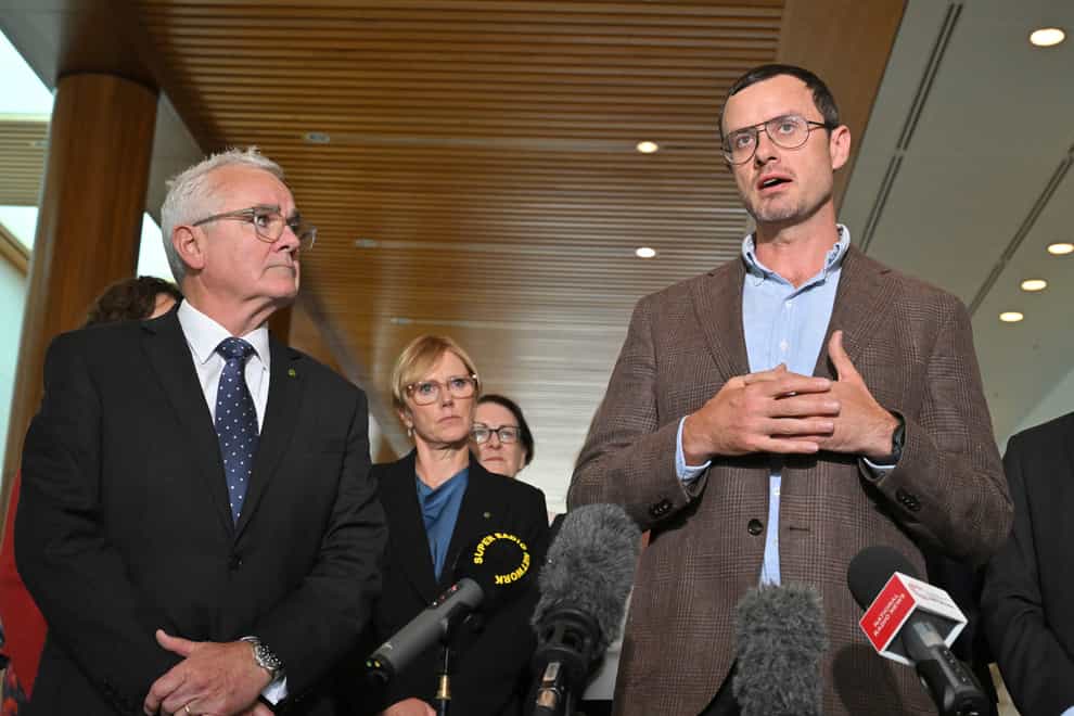 Independent member of parliament Andrew Wilkie, left, and Julian Assange’s brother Gabriel Shipton, right, speak to the media at Parliament House in Canberra (Mick Tsikas/AAP Image via AP)