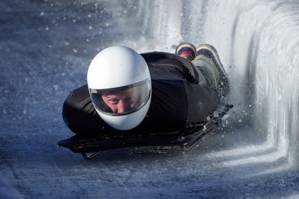 The Duke of Sussex hits the wall as he slides down the track on a skeleton sled during an Invictus Games training camp, in Whistler, British Columbia (Darryl Dyck/The Canadian Press via AP)