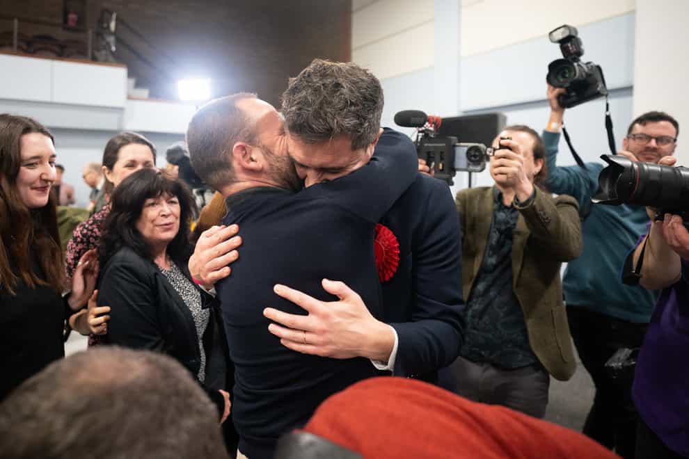 Labour’s Damien Egan embraces his husband after winning the Kingswood by-election, the first of Labour’s two by-election victories declared early on Friday (Ben Birchall/PA)