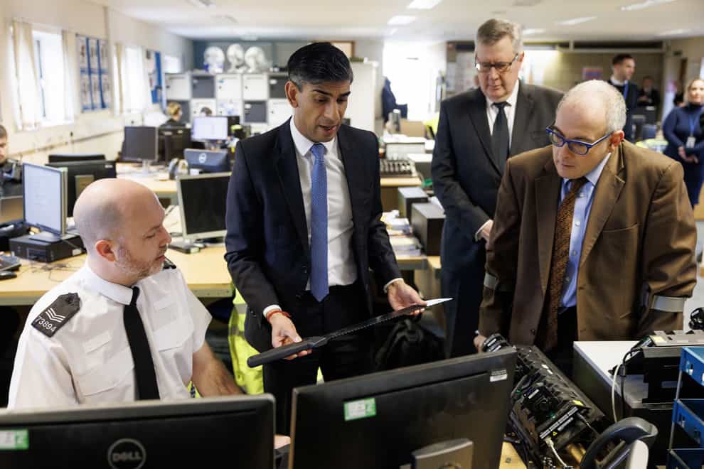 Prime Minister Rishi Sunak picks up a ‘zombie knife’ while visiting Harlow police station in Essex (Dan Kitwood/PA)