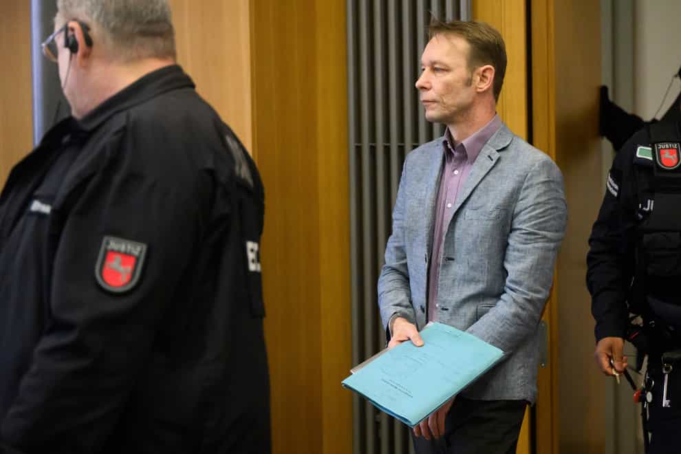 Christian Brueckner arrives at the start of his trial at Braunschweig district court in Germany (Julian Stratenschulte/dpa via AP)
