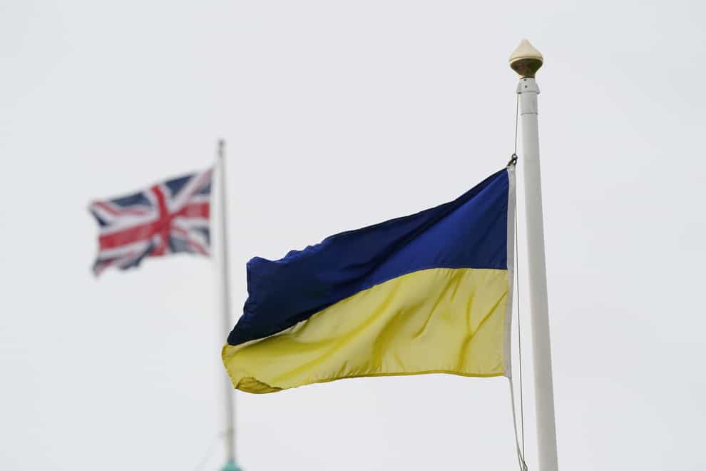A Ukrainian and Union flag flying (PA)