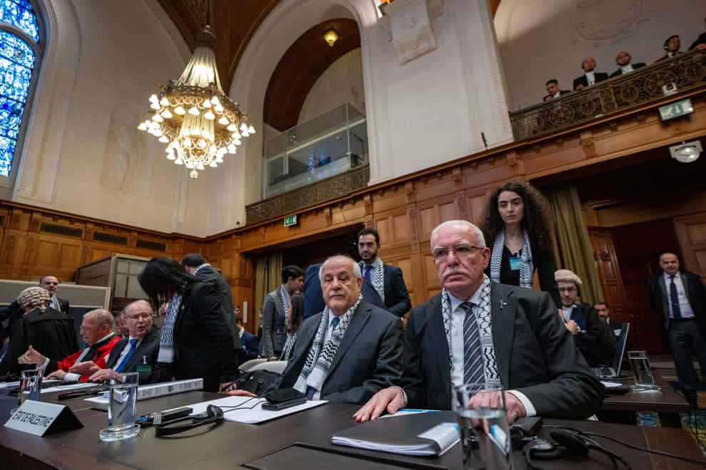 Riyad Al-Maliki, minister of Foreign Affairs of the Palestinian National Authority, right, and Riyad Mansour, representative of the Palestinian National Authority at the UN, second right, wait for the United Nations’ highest court to open hearings in The Hague (Peter Dejong/AP)