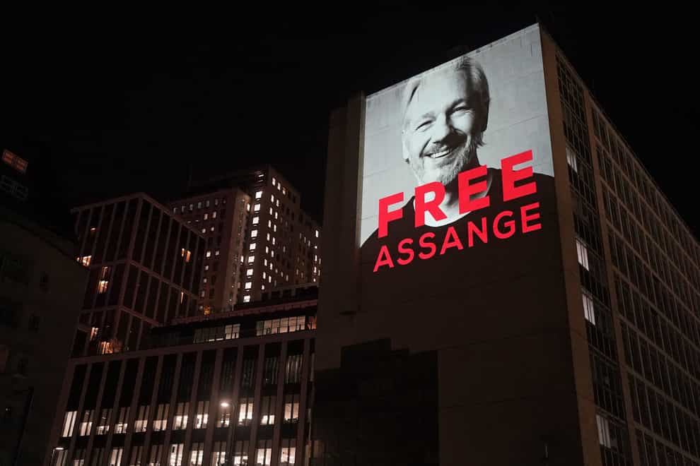 An image of Julian Assange is projected onto a building in Leake Street in central London, to mark three years since his arrest and detention in Belmarsh prison while the United States continues with legal moves to extradite him. Picture date: Sunday April 10, 2022.