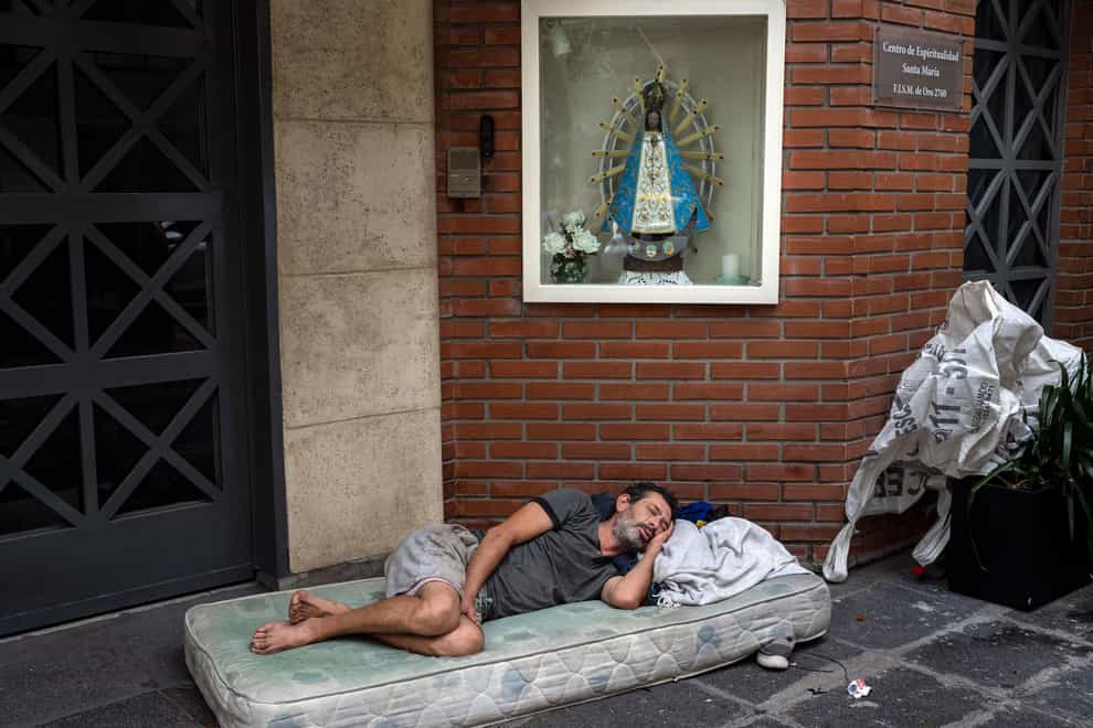 Agustin Catamano, 48, who said he is homeless, sleeps on the streets of Buenos Aires (Rodrigo Abd/AP)