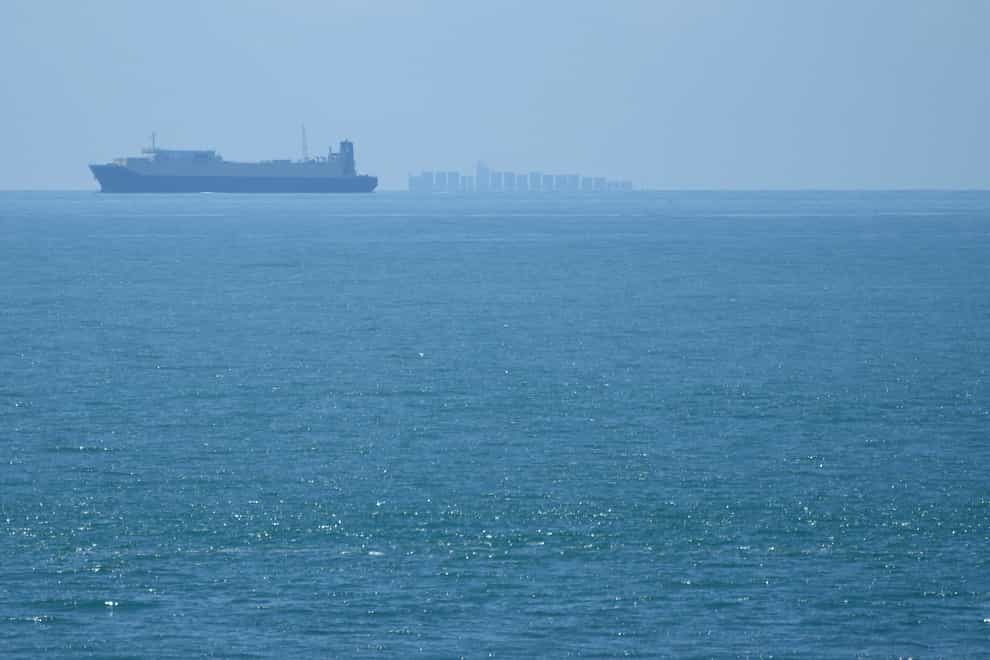 Ships move through the Taiwan Strait as seen from the 68-nautical-mile scenic spot, the closest point in mainland China to the island of Taiwan, in Pingtan (Ng Han Guan/AP)