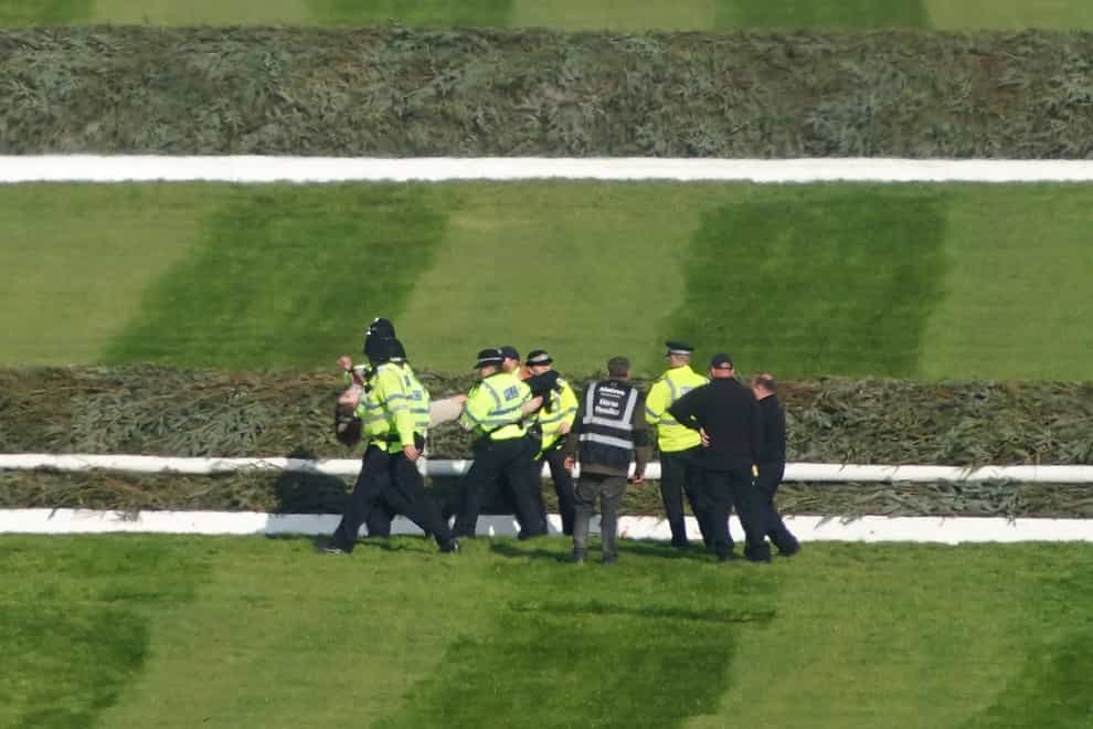 Police officers respond to Animal Rising activists at Aintree (PA)