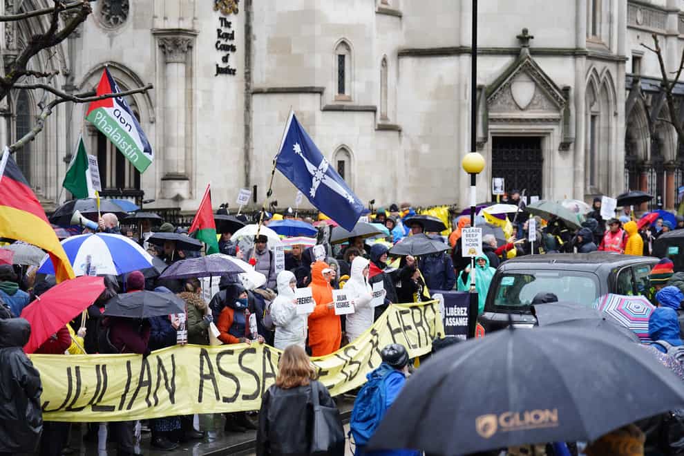 Protesters lined up outside the Royal Courts of Justice in London during the hearing (James Manning/PA)