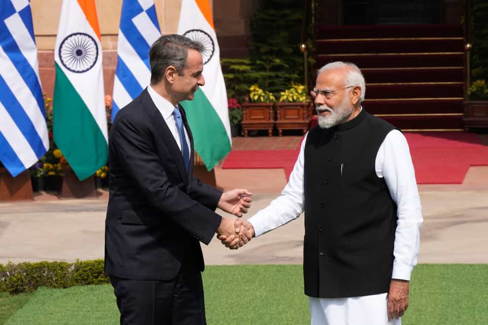 Greece’s Prime Minister Kyriakos Mitsotakis, left, talks with his Indian counterpart Narendra Modi as he arrives for a delegation level meeting in New Delhi (Manish Swarup/AP)