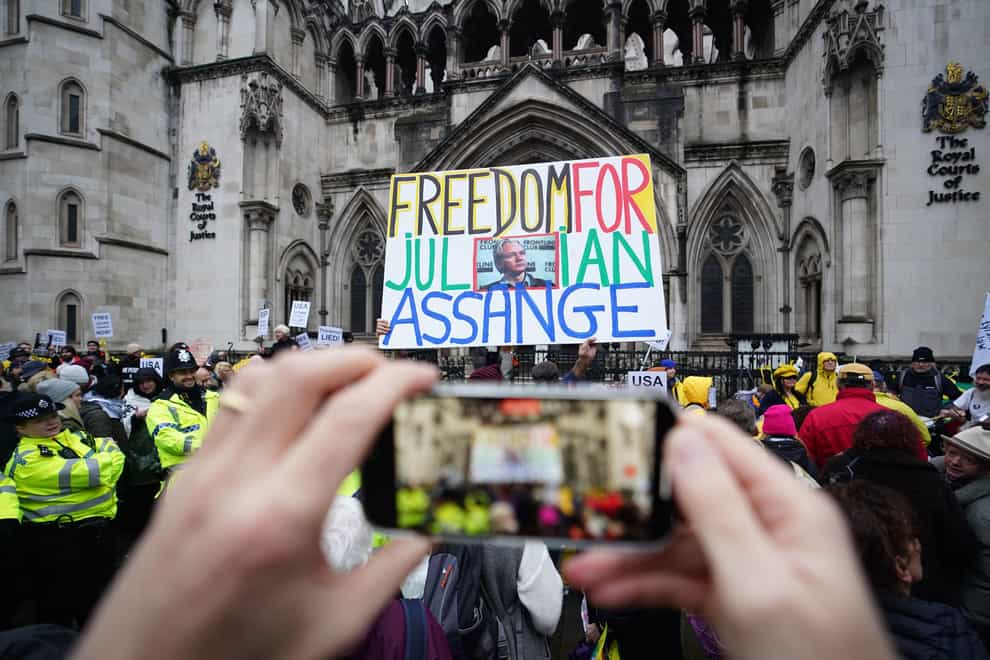 Julian Assange supporters outside the Royal Courts of Justice in London during a hearing in the extradition case of the WikiLeaks founder (James Manning/PA)