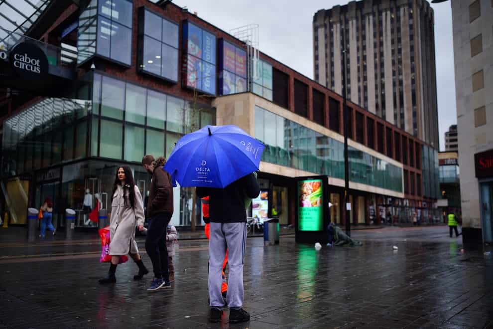 People with umbrellas (Ben Birchall/PA)