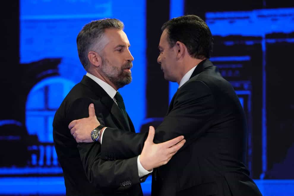 Socialist Party leader Pedro Nuno Santos, left, and Luis Montenegro, leader of the Social Democratic Party, greet each other before an election TV debate in Lisbon, Portugal (Armando Franca/AP)