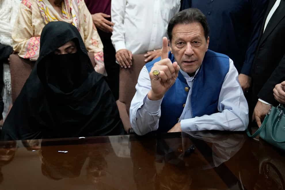 Imran Khan, right, and Bushra Bibi, his wife, have appeared in court (KM Chaudary/AP)