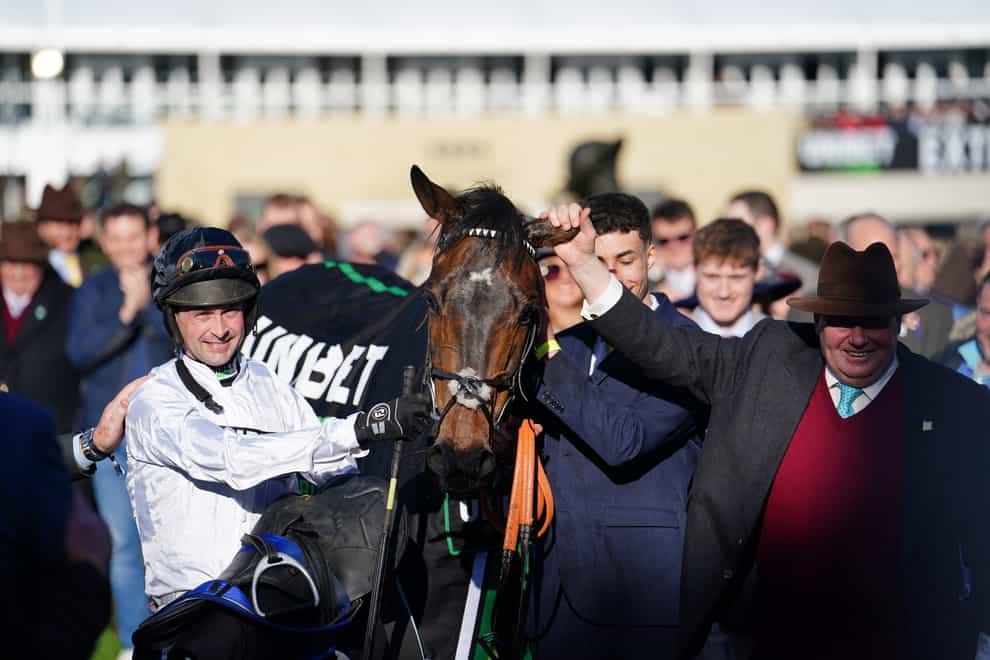Nico de Boinville (right) and trainer Nicky Henderson celebrate winning The Unibet Champion Hurdle Challenge Trophy on Constitution Hill on day one of the Cheltenham Festival at Cheltenham Racecourse. Picture date: Tuesday March 14, 2023.