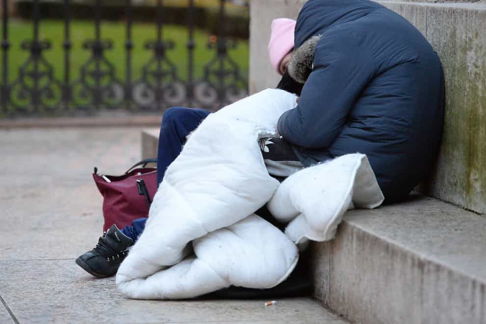 Homeless people sleeping on the plinth of the Ferdinand Foch equestrian statue in Victoria, London (Nicholas T Ansell/PA)