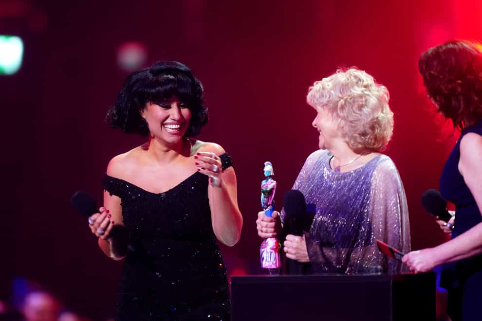 Raye on stage after winning the award for Song of the Year with a victim of the Post Office scandal (James Manning/PA)