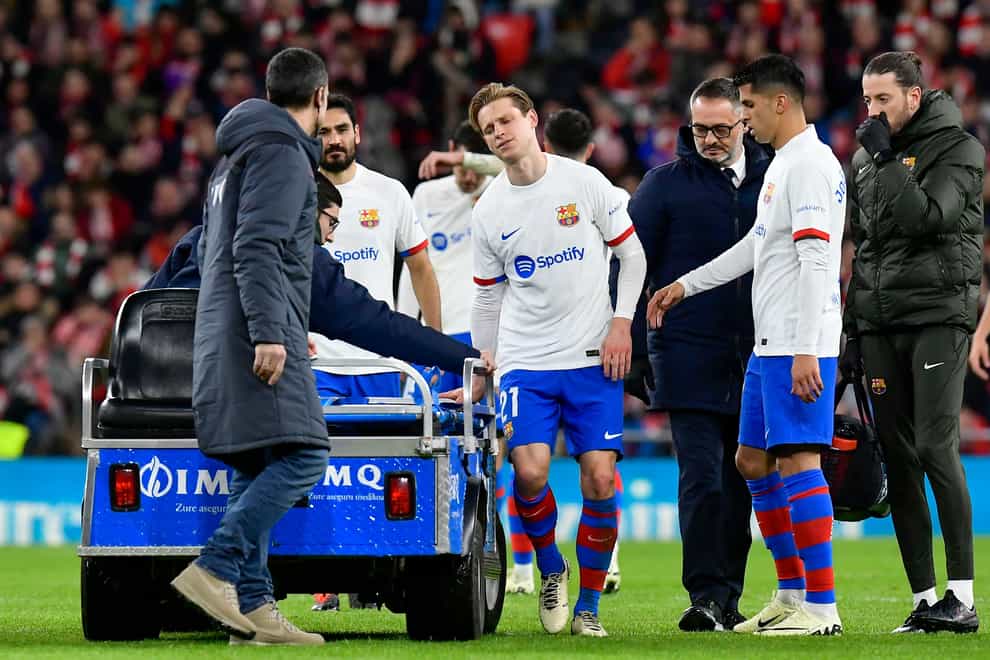 Barcelona’s Frenkie de Jong leaves the field after sustaining an injury at Athletic Bilbao (Alvaro Barrientos/AP)