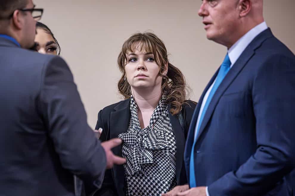 Rust movie armourer Hannah Gutierrez-Reed, centre, talks with her attorney Jason Bowles, right, and her defence team during her involuntary manslaughter trial (Jim Weber/Santa Fe New Mexican via AP, Pool)