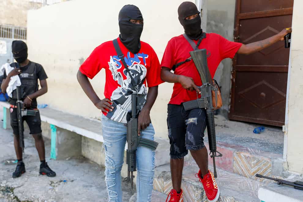 Gang members pose for a photo in Haiti (Odelyn Joseph/AP)