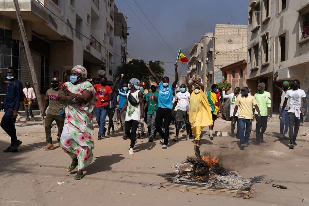 Demonstrators protest against President Macky Sall’s decision to postpone the election (Stefan Kleinowitz/AP)