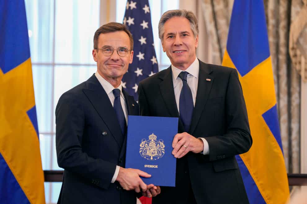 Secretary of State Antony Blinken poses for a photo with Swedish Prime Minister Ulf Kristersson holding Sweden’s Nato instruments of accession (Jess Rapfogel/AP)