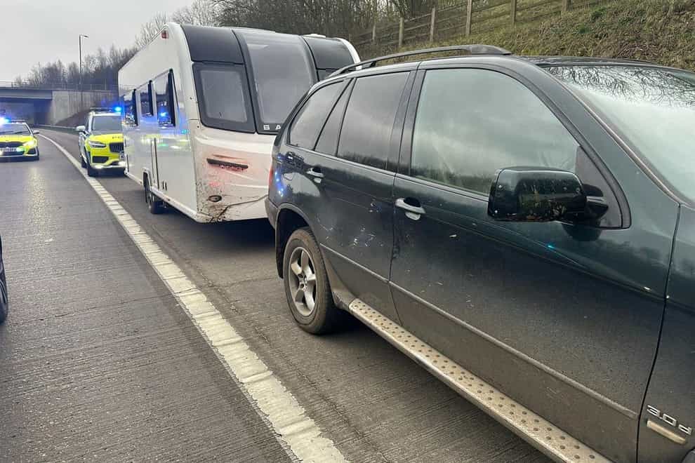 An 11-year-old boy was arrested after being stopped by police at the wheel of a BMW towing a suspected stolen caravan on the M1 (North Yorkshire Police/PA)
