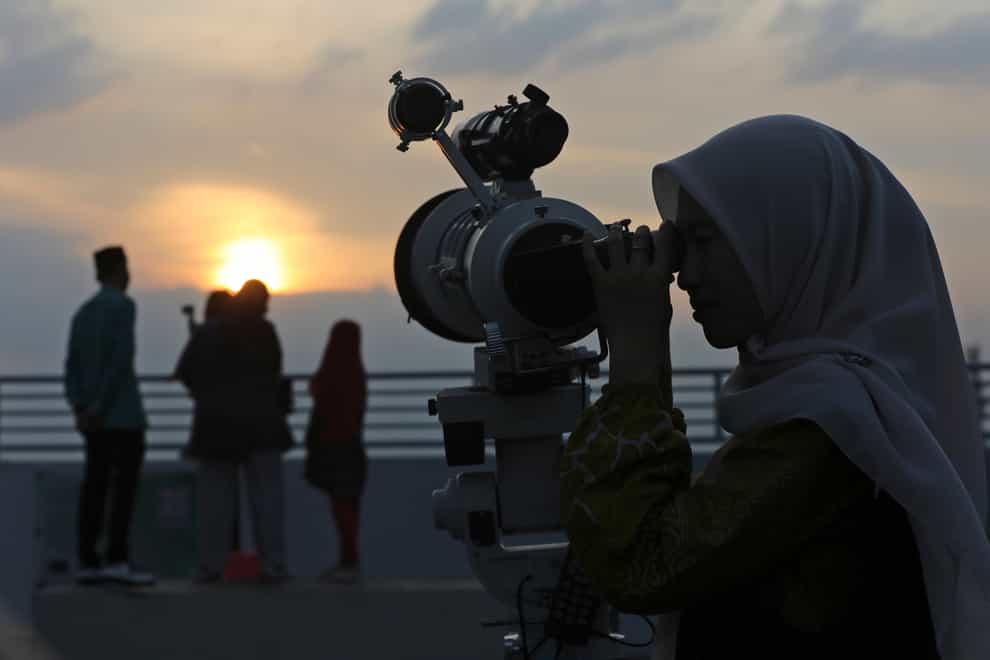 A member of staff uses a telescope to search the sky for the new moon that signals the start of the Islamic holy fasting month of Ramadan, at the Astronomical Observatory of the Muhammadiyah University of North Sumatra in Medan, Indonesia (AP Photo/Binsar Bakkara)