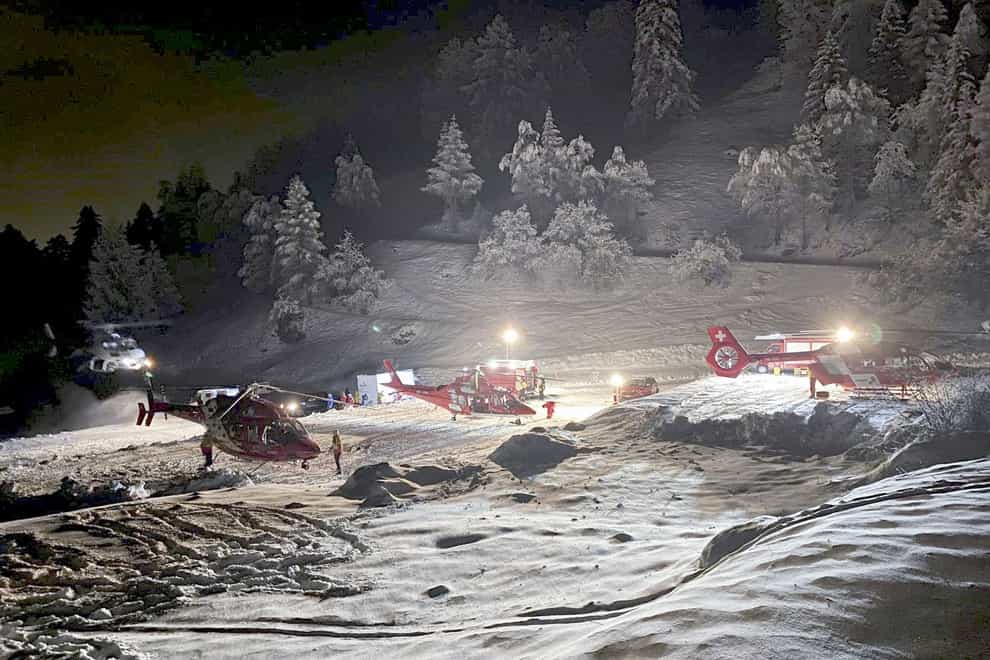 Mountain rescuers and helicopters (Valais cantonal police via AP)