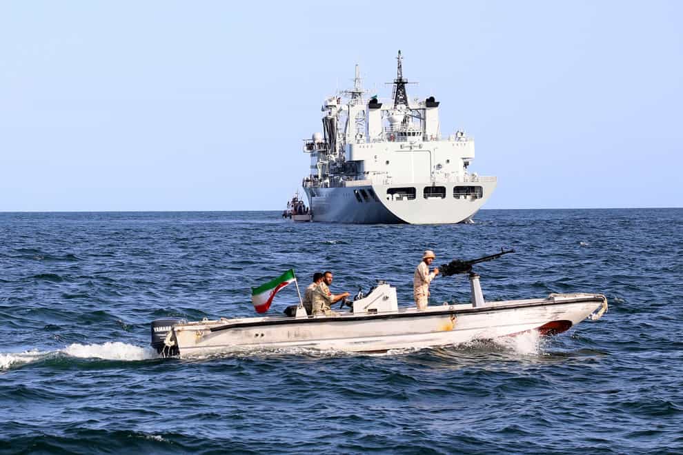 An Iranian military boat patrols as a warship enters the Iranian waters prior to start of a joint naval drill of Iran, Russia and China in the Indian Ocean (Iranian Army/AP)