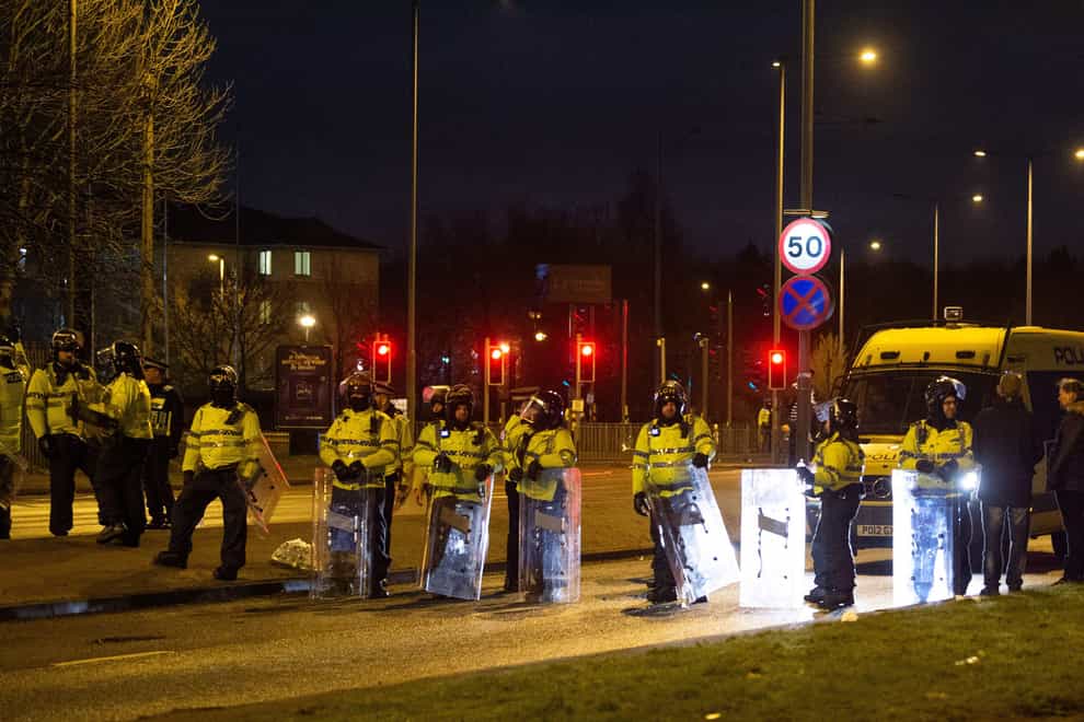 Police in riot gear after a demonstration outside the Suites Hotel in Knowsley, Merseyside (Peter Powell/PA)