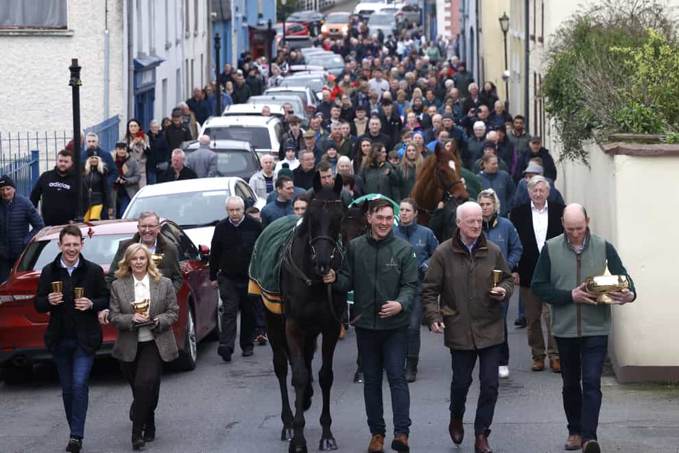 Jockey Paul Townend, owner Audrey Turley, 2024 Boodles Cheltenham Gold Cup winner Galopin Des Champs, groom Adam Connolly, trainer Willie Mullins, and owner Greg Turley (left-right) lead the parade of the Boodles Cheltenham Gold Cup 2024 winners homecoming through Leighlinbridge, Ireland (Damien Eagers/PA)