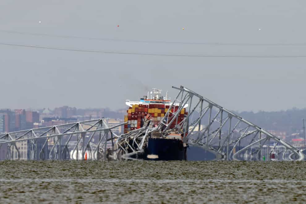 A container ship rests against wreckage of the Francis Scott Key Bridge (Mark Schiefelbein/AP)
