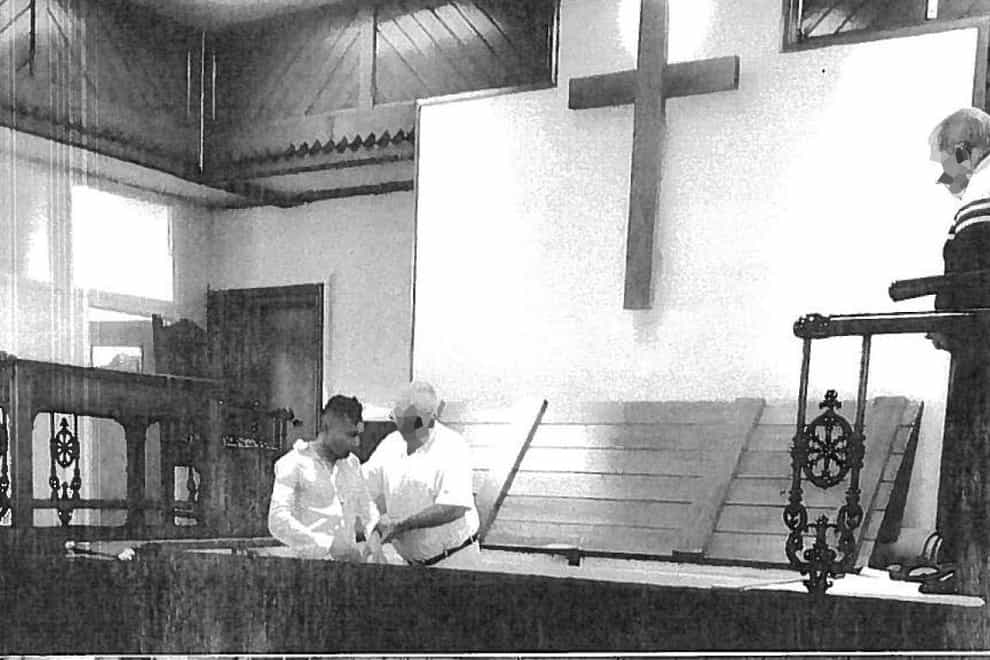 Abdul Ezedi, left, being baptised (Judicial Office/PA)