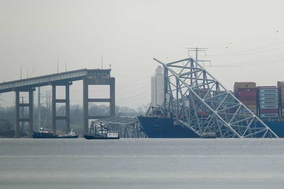 A container ship rests against wreckage of the Francis Scott Key Bridge (AP)