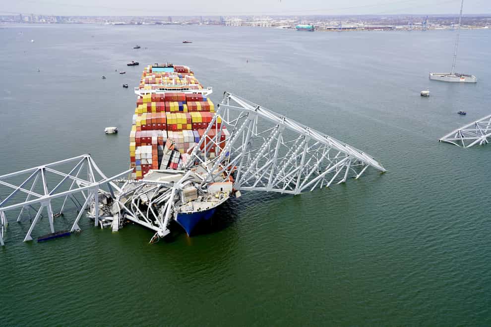 The cargo ship Dali stuck under part of the structure of the Francis Scott Key Bridge after the ship hit the bridge in Baltimore (Maryland National Guard via AP)