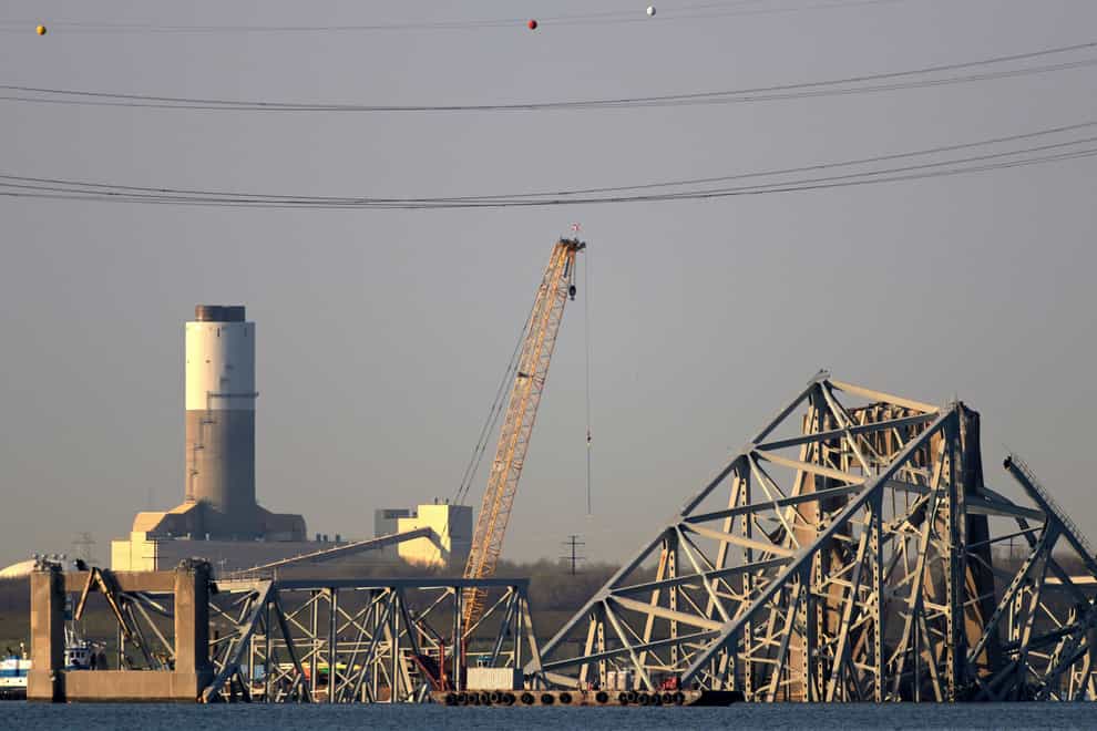 A crain is seen near the wreckage of the Francis Scott Key Bridge (Steve Ruark/AP)